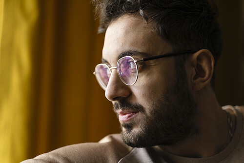 Handsome glasses man looking out the window