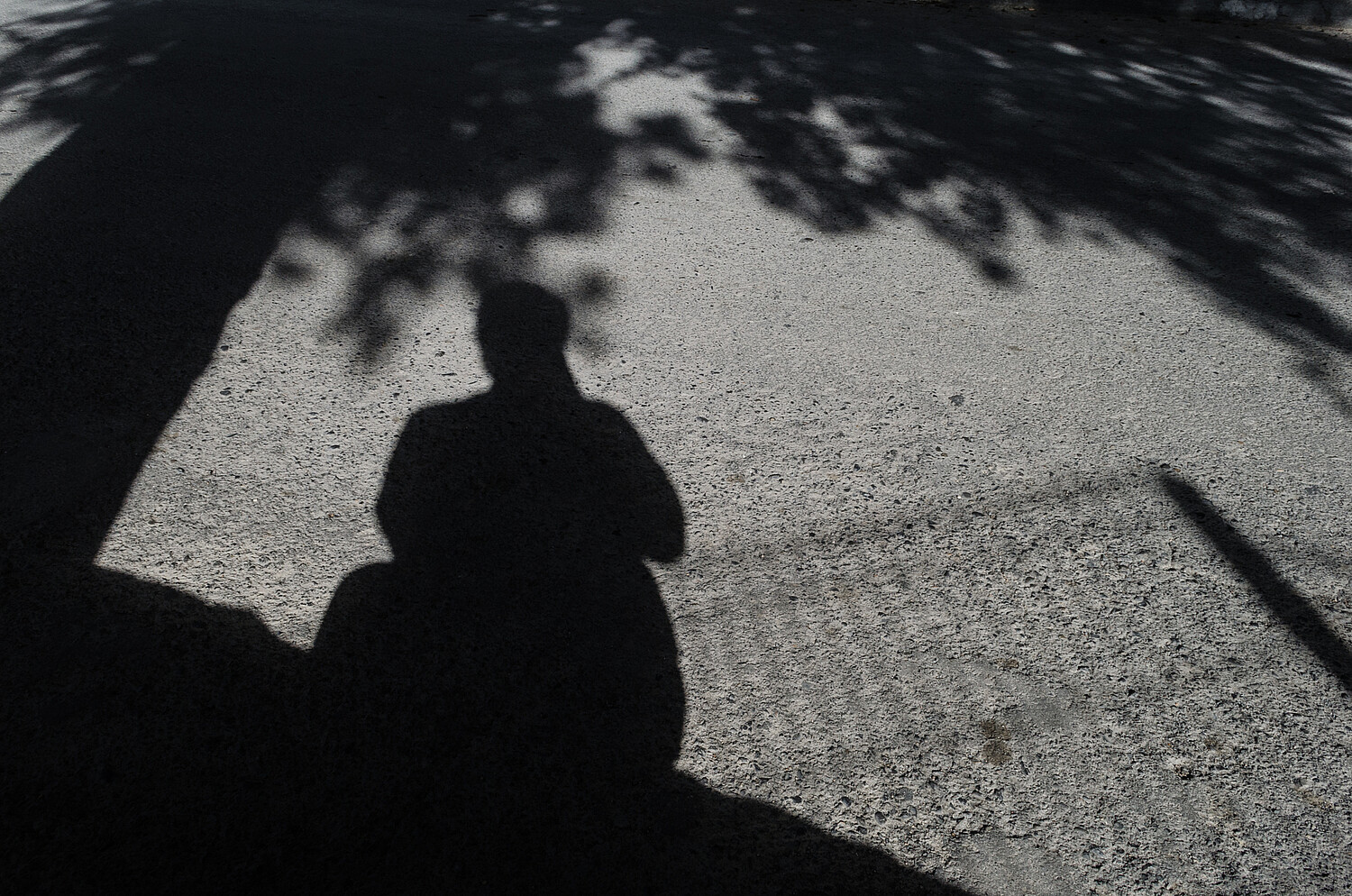 the shadow of a man holding a camera, self-portrait of a tourist photographer